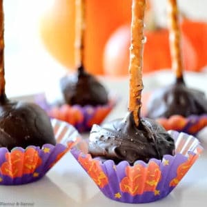 Chocolate Coconut pops in Halloween candy liners with a pretzel stick