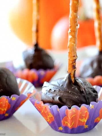 Chocolate Coconut pops in Halloween candy liners with a pretzel stick