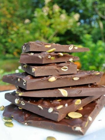 Salted Dark Chocolate Bark with Pumpkin Seeds stacked on a plate