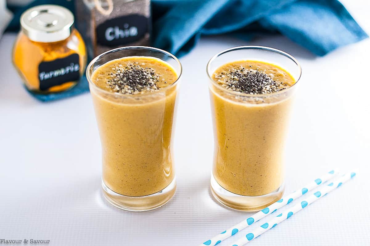 Mango tropical turmeric smoothie glasses with chia and hemp seeds