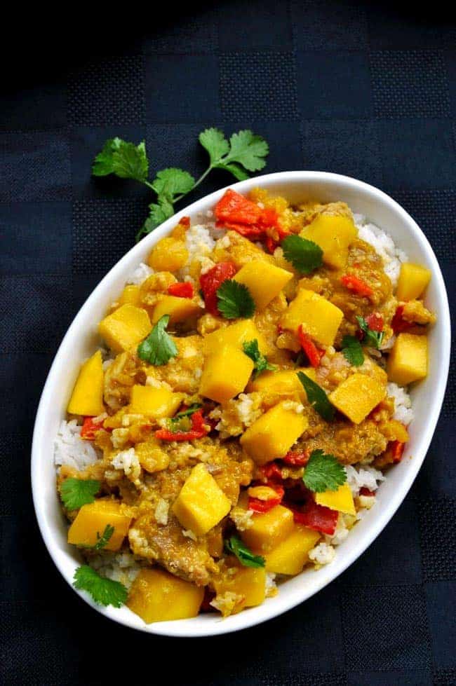 Overhead view of a bowl of mango chicken with diced mango