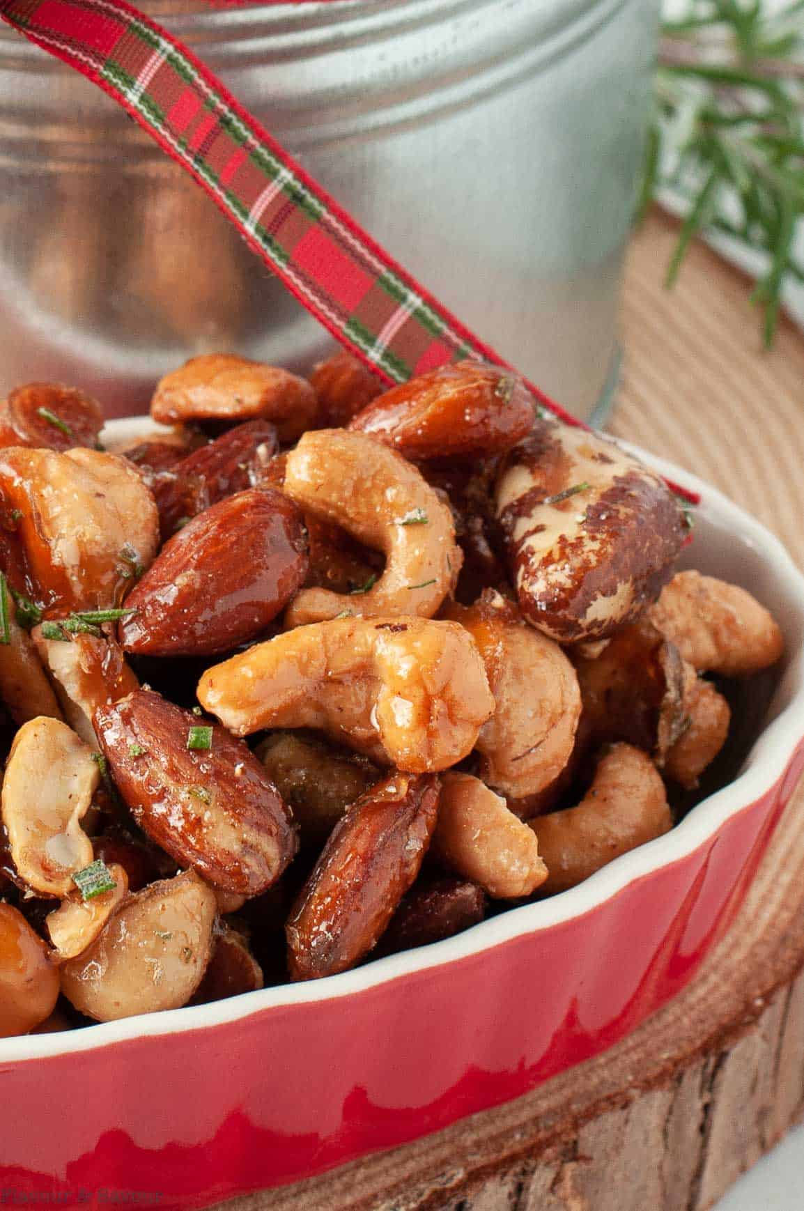 Close up view of rosemary nut mix in a small red dish