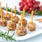 Mini Cheese Balls with pretzel sticks and grapes in the background