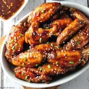 Close up view of a bowl of chipotle chicken wings.