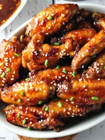 Close up view of a bowl of chipotle chicken wings.