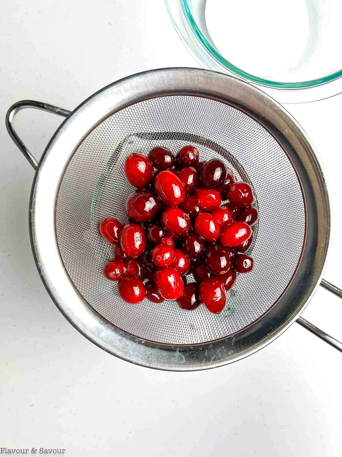 Cranberries in a sieve.
