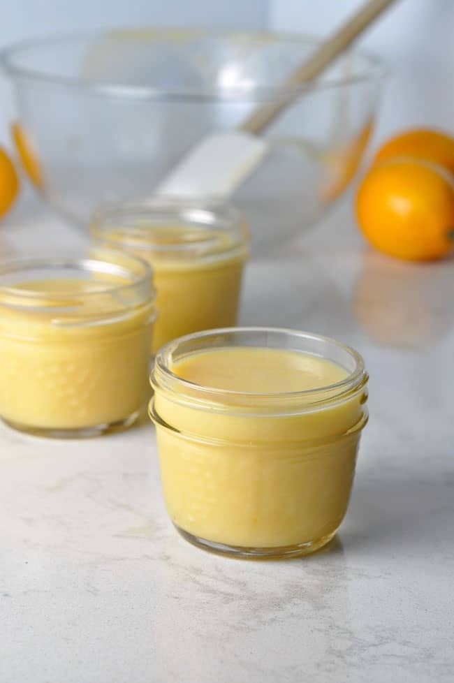 How to Make Paleo Lemon Curd, and why you should! Close up view of small Mason jars filled with Paleo Lemon Curd.
