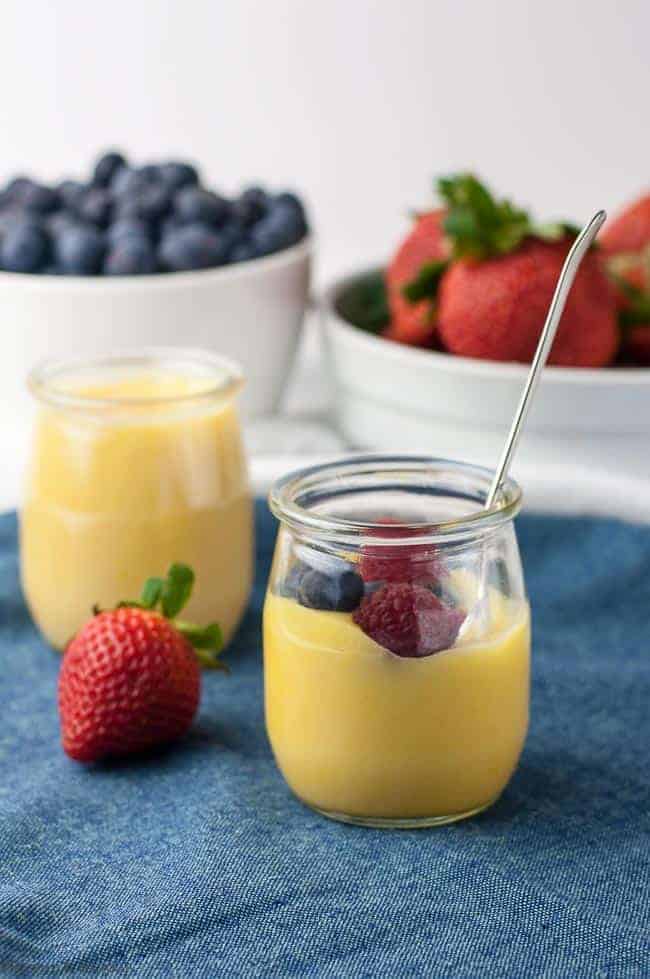 Homemade Paleo Lemon Curd in tiny pots with fresh berries