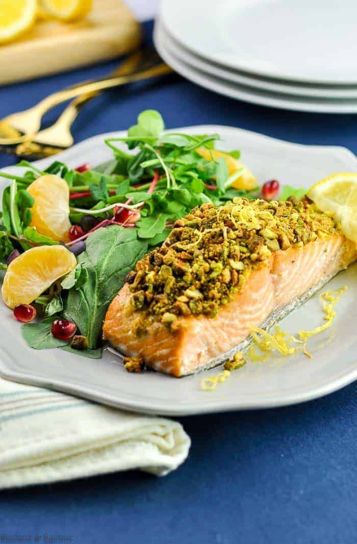 Baked Pistachio-Crusted Salmon with salad on gray plate