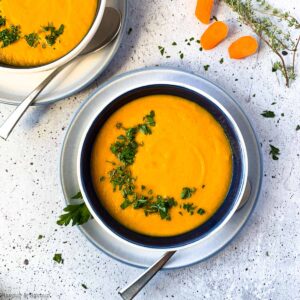 overhead view of a bowl of carrot ginger soup