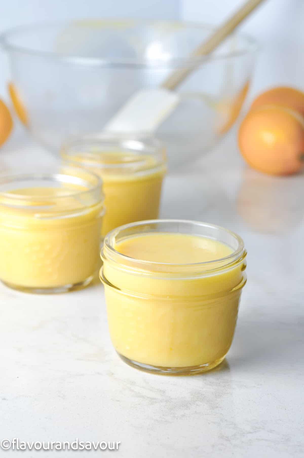 Lemon curd in small Mason jars.