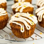 carrot ginger muffins with cream cheese glaze on a cooling rack