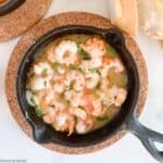 a skillet with gin-gingered prawns