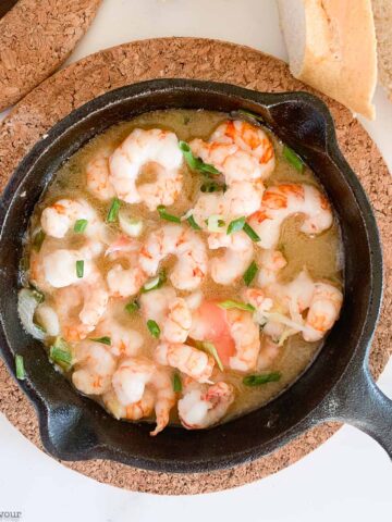 a skillet with gin-gingered prawns