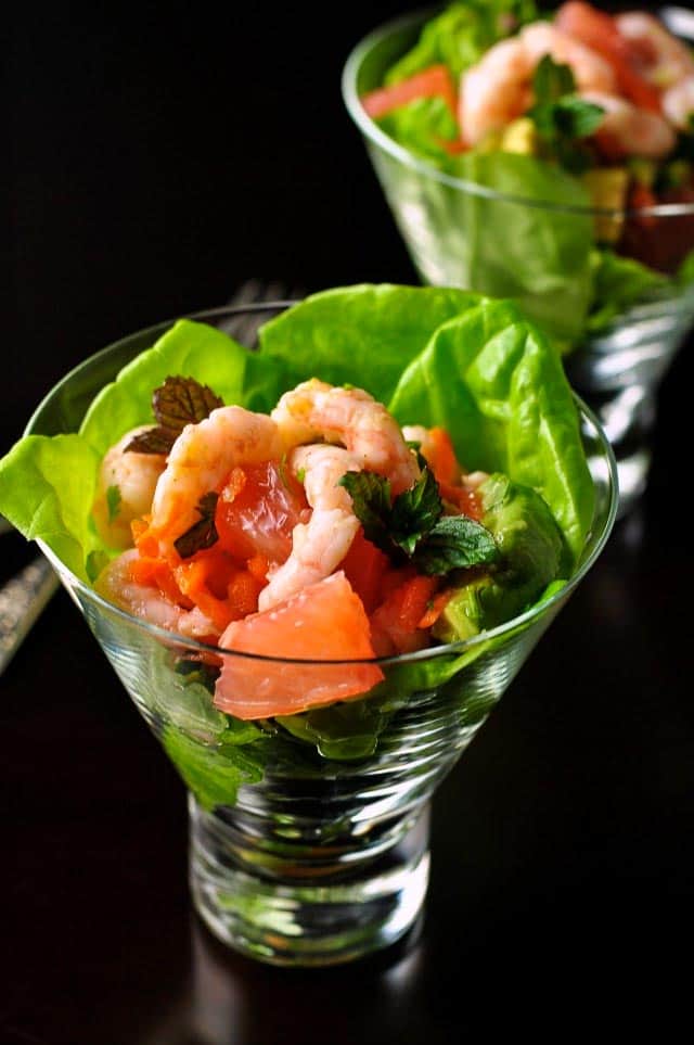 Tender butter lettuce and sweet rosy pink grapefruit form the bed for a gently spiced mound of shrimp with just a hint of heat. This Shrimp Salad with Grapefruit and Mint has it all: shrimp, avocado, shallots, carrot, cilantro, and grapefruit, all topped off with some fresh mint and crunchy salted peanuts.