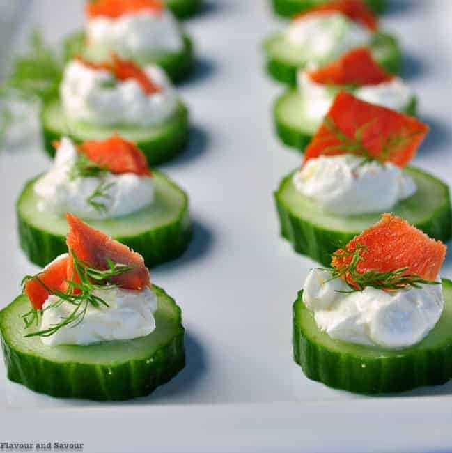 Close up view of Smoked Salmon Cucumber Bites garnished with fresh dill.