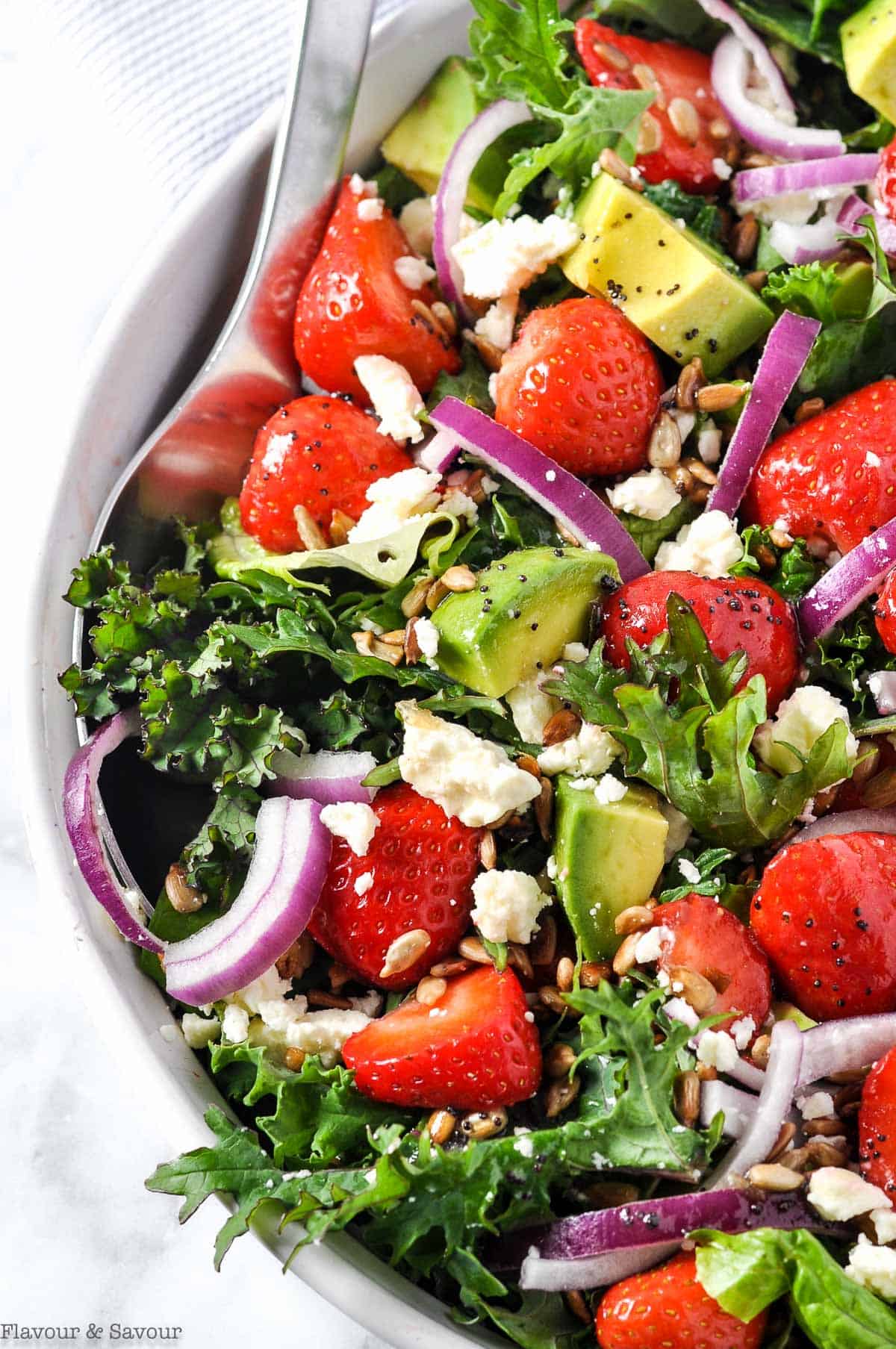 Close up view of Strawberry Kale Salad with Poppy Seed Dressing
