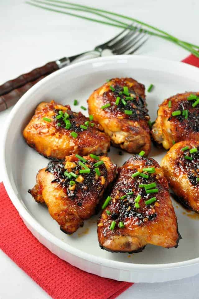 Tender, juicy chicken thighs glazed with an Asian-inspired sauce with a little heat and hints of garlic, sesame and ginger.
