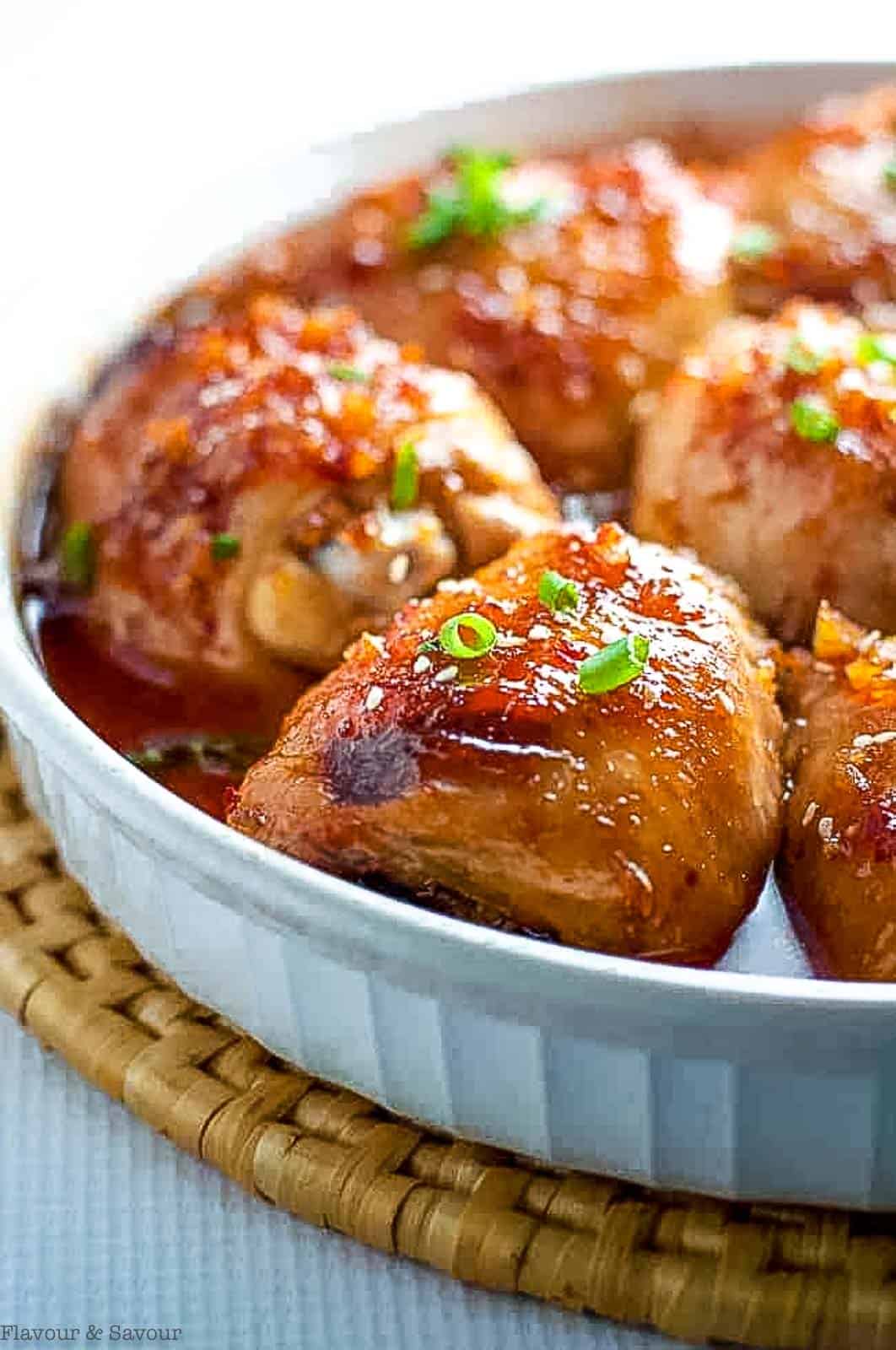 Close up view of a platter of Asian Glazed Garlic Chicken thighs.