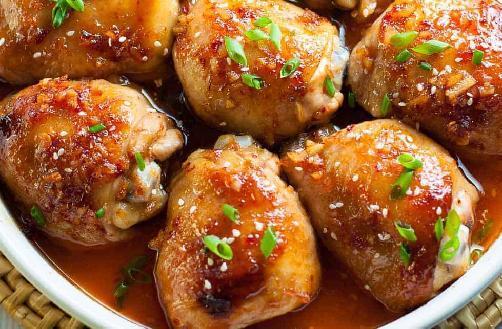 This Asian Glazed Garlic Chicken features tender, juicy chicken thighs glazed with an Asian-inspired sauce. It has a little heat and hints of garlic, sesame and ginger.|www/flavourandsavour.com