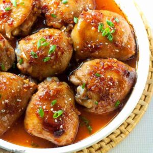 A platter with Asian Glazed Garlic Chicken thighs.