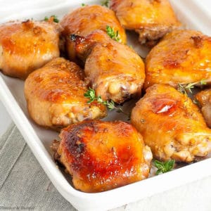 9 Maple Garlic Glazed Chicken thighs on a square white dish