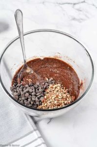 Adding nuts and chocolate chips to brownie batter