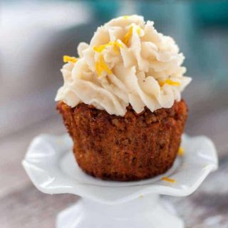 Paleo Carrot Cake Cupcakes with Coconut Butter Frosting. A single cupcake on a cupcake pedestal stand.