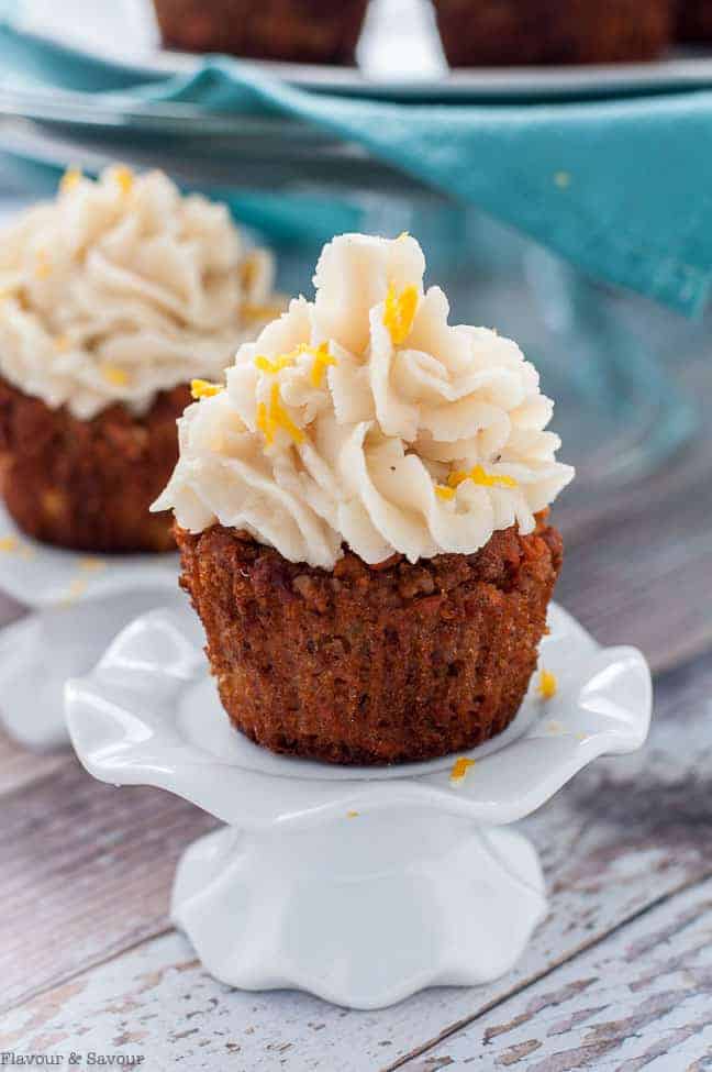 Paleo Carrot Cake Cupcakes with Coconut Butter Frosting on a pedestal stand