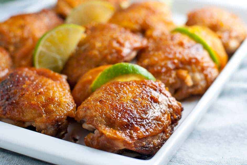 Chipotle Peach Glazed Chicken Thighs on a serving platter. Close up view.