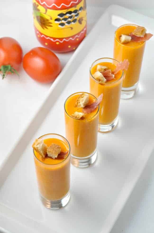 overhead view of four shot glasses of Salmorejo, chilled Spanish tomato soup