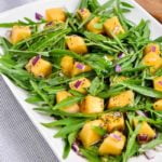 Cantaloupe Arugula Salad on a white platter