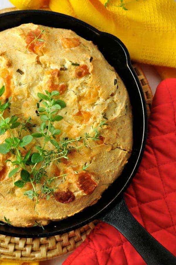 Gluten-Free Cheesy Herb Cornbread baked in a cast iron skillet