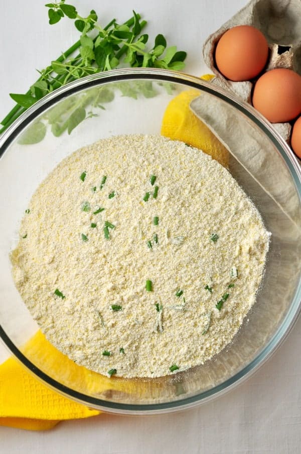 Ingredients for Gluten-free Cheesy Herb Cornbread in a glass bowl