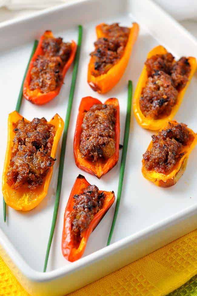 Spicy Stuffed Mini Peppers on a white dish with chives