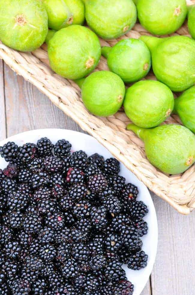 A basket of fresh figs and a bowl of blackberries