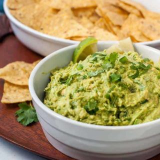 Quick chunky guacamole with a bowl of tortilla chips
