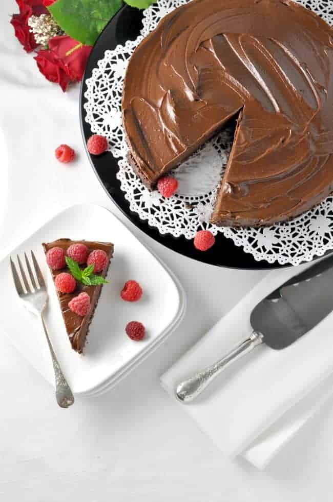 Vegan Double Chocolate Mousse Torte topped with fresh raspberries.