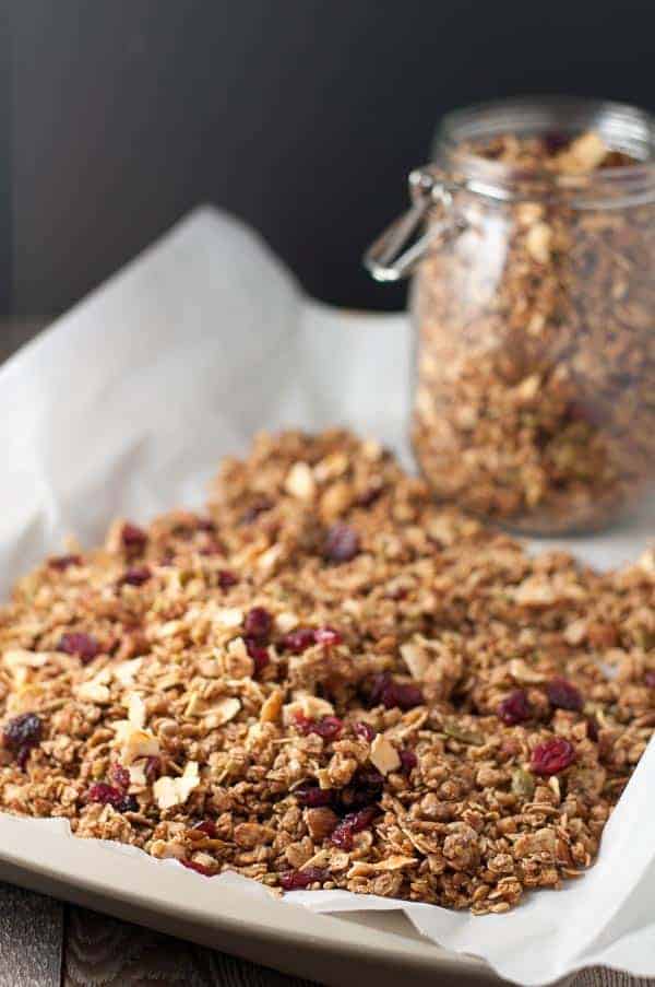 Apple Cinnamon Granola on a parchment paper-lined baking sheet