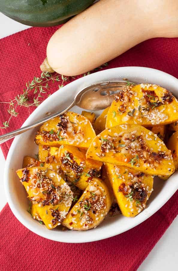 Chili Garlic Glazed Butternut Squash in a bowl with whole squash in background
