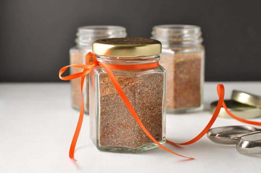 How to Make Taco Seasoning Mix in less than 5 minutes. Small jars decorated with orange ribbon.