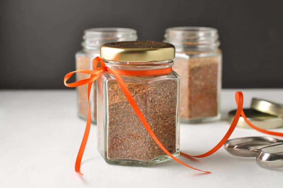 How to Make Taco Seasoning Mix in less than 5 minutes. Small jars decorated with orange ribbon.
