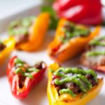 Taco Stuffed Mini Peppers. Little bites filled with taco meat and cheese and topped with avocado cream. Game-Day snack!