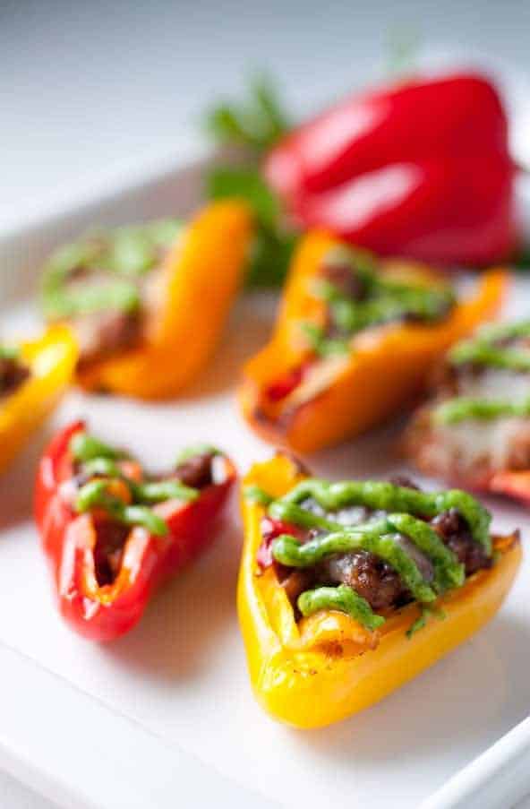 Taco Stuffed Mini Peppers. Little bites filled with taco meat and cheese and topped with avocado cream. Game-Day snack!