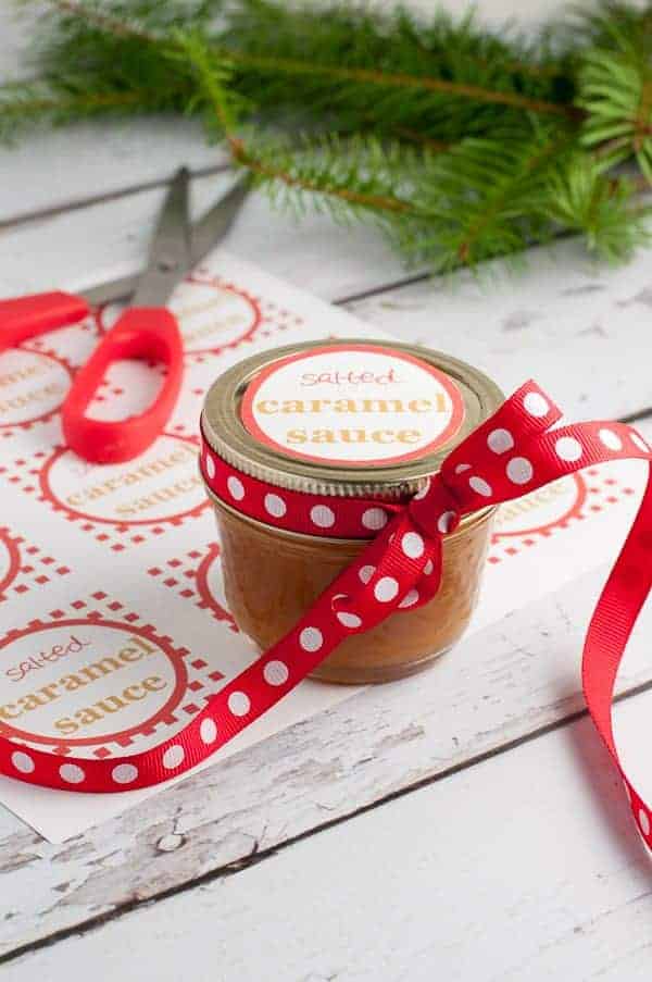 Salted Caramel Sauce in a small jar with a ribbon and a label.