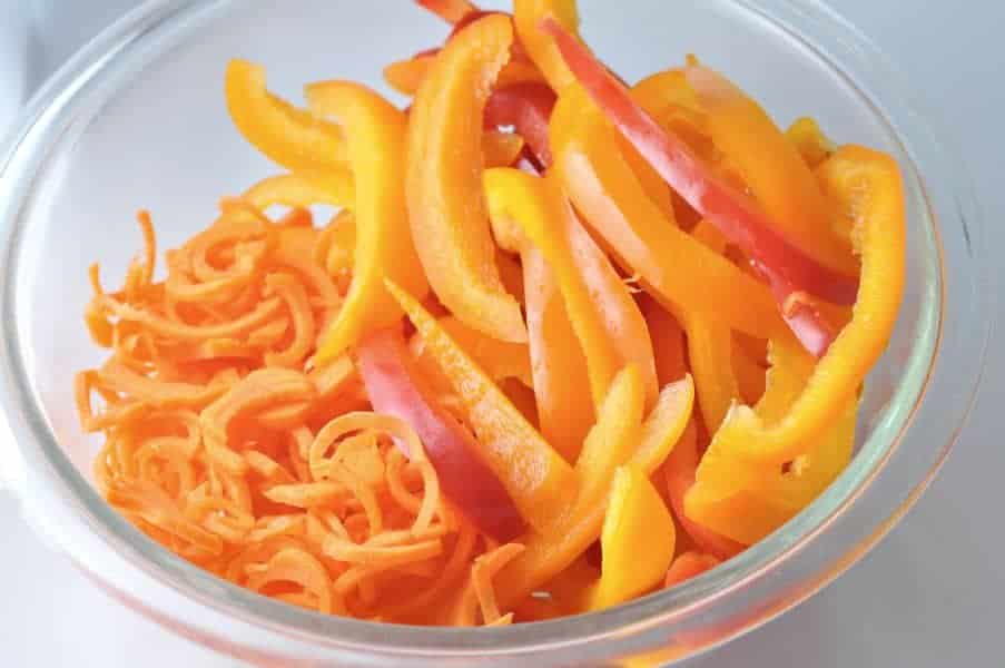 julienned peppers and carrots in a glass bowl