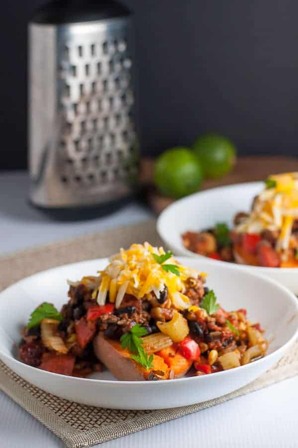 Chipotle Chili Stuffed Sweet Potatoes with a cheese grater in the background