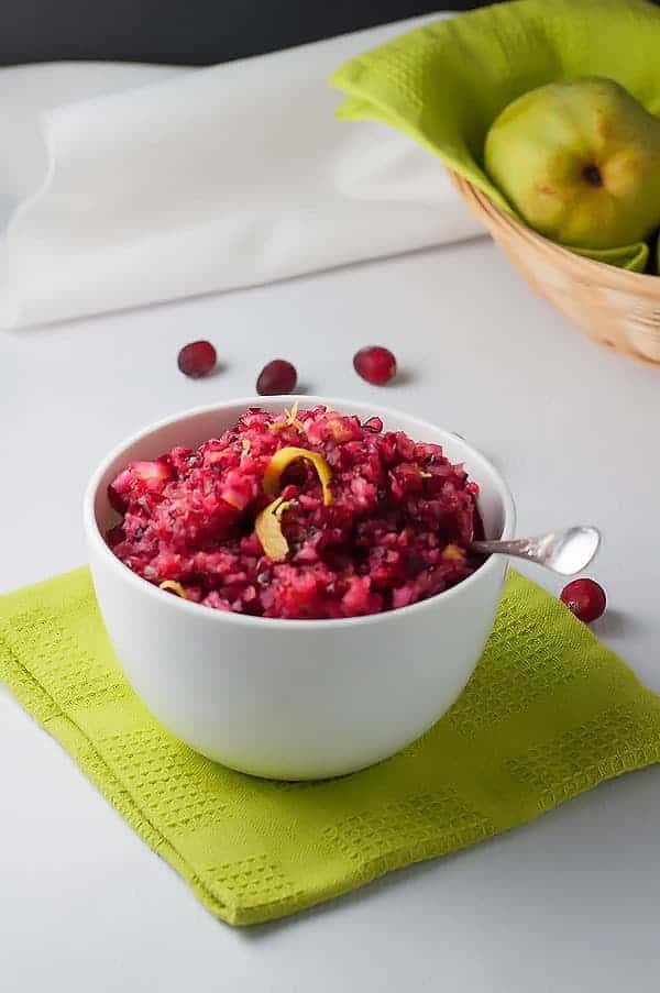 Cranberry Lemon and Pear Relish in a bowl with fresh pears in a basket
