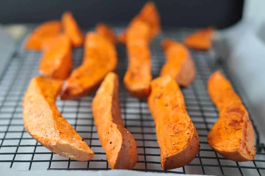 Smoky Sweet Potato Wedges that don't stick to the pan! Shown on a baking rack.