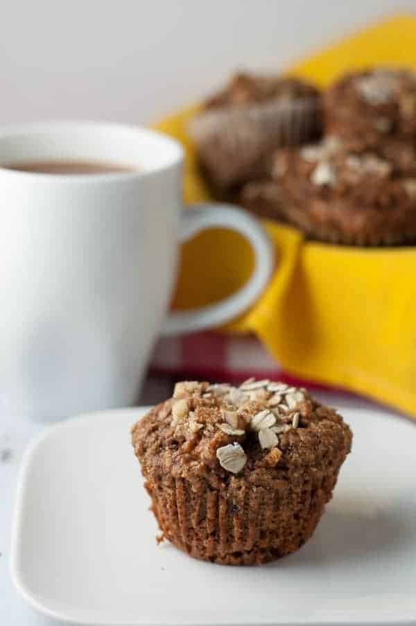 Apple Oatmeal Breakfast Muffins. Close up view of a muffin topped with oat flakes